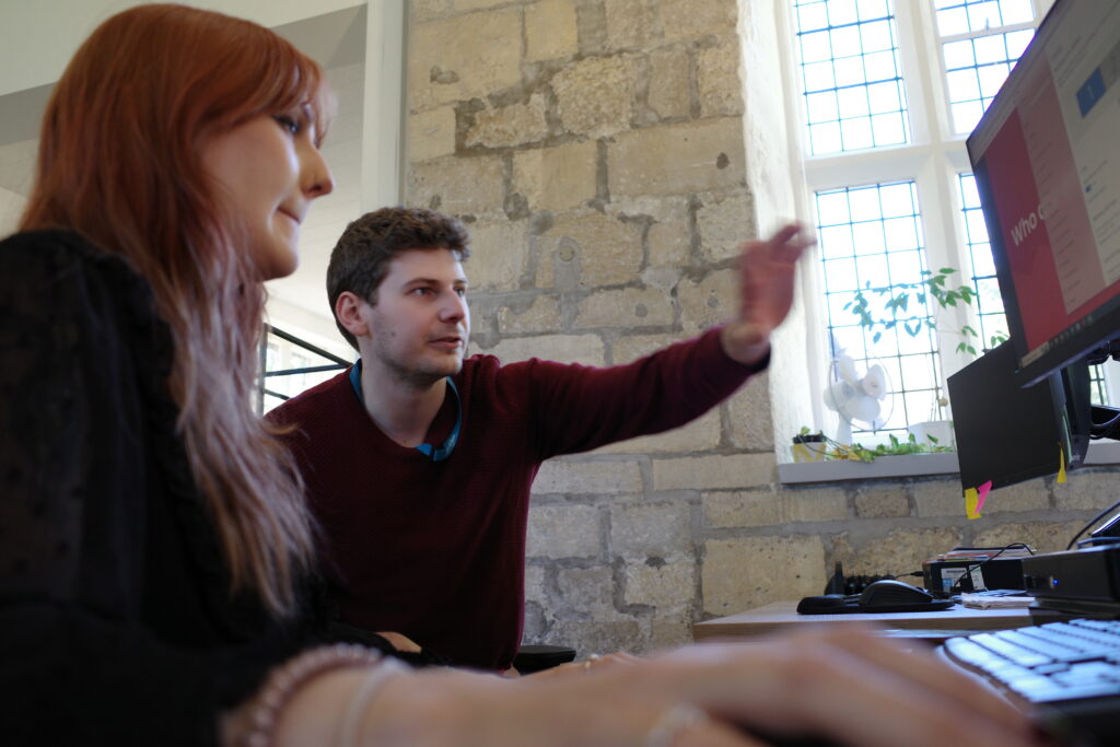 Photo of ADS staff explaining something to another staff member